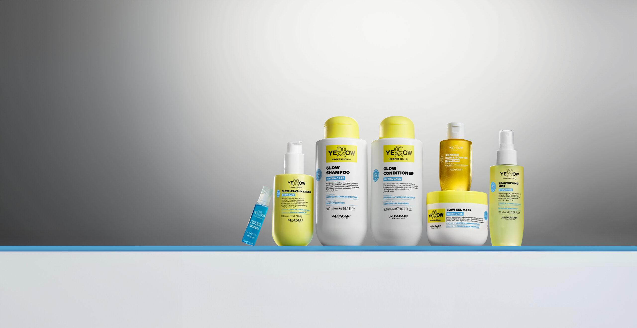 Linha completa Yellow Hydra Care reunida em uma composição de estúdio, destacando shampoo, condicionador, máscara, leave-in, óleo iluminador, spray multifuncional e sérum. A coleção da Yellow Professional aposta em hidratação, brilho e cuidado diário com fórmulas enriquecidas por Lumitech e extrato de tamarindo.