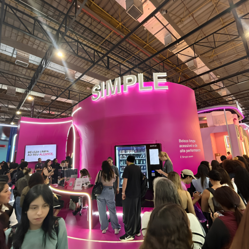 Estande da Simple Organic na Beauty Show 2026 reúne grande público em torno da estrutura rosa em formato de "S", destacando o reposicionamento da marca, a beleza limpa e as ativações interativas para os visitantes.