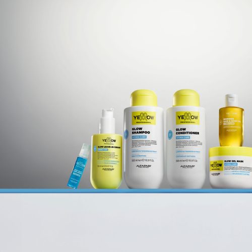 Linha completa Yellow Hydra Care reunida em uma composição de estúdio, destacando shampoo, condicionador, máscara, leave-in, óleo iluminador, spray multifuncional e sérum. A coleção da Yellow Professional aposta em hidratação, brilho e cuidado diário com fórmulas enriquecidas por Lumitech e extrato de tamarindo.